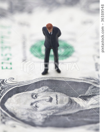 Financial crisis. Figure of businessman on one usd 36389548