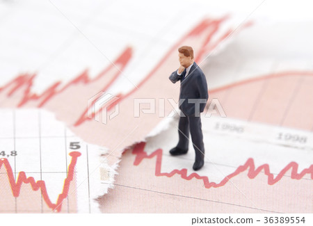 Figure of businessman on financial charts Figure of businessman on financial charts 36389554