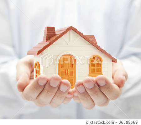 Small orange toy house in hands  36389569