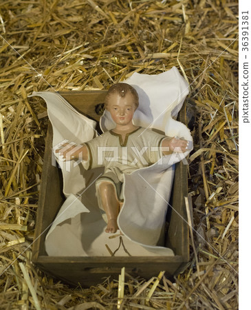 Baby Jesus laying in a cradle 36391381