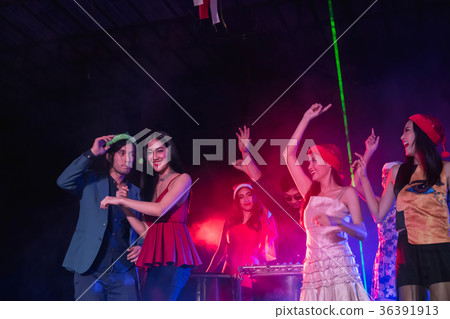 Teenagers are celebrating at the night party. Teenagers are celebrating at the night party. 36391913