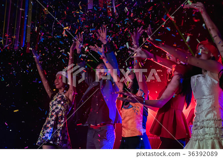 Teenagers are celebrating at the night party. 36392089