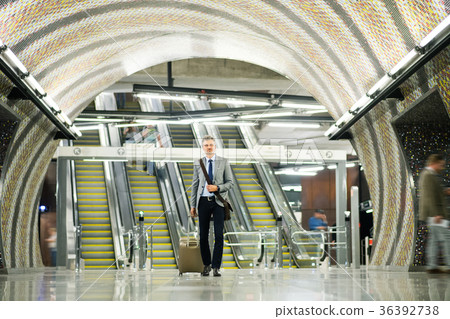 Businessman in front of escalators on a metro 36392738