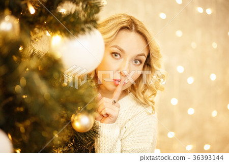 secret. beautiful girl with his finger near the secret. beautiful girl with his finger near the 36393144