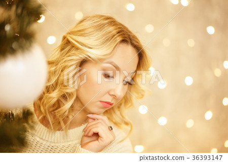 Beautiful young woman looks for a Christmas tree Beautiful young woman looks for a Christmas tree 36393147