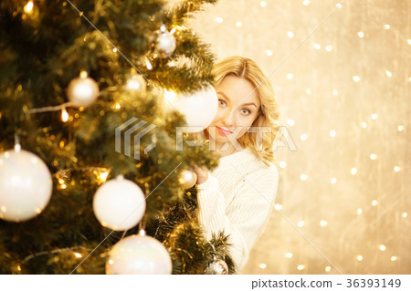 Beautiful young woman looks for a Christmas tree Beautiful young woman looks for a Christmas tree 36393149
