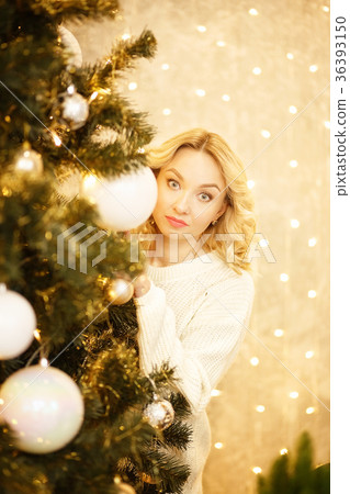 Beautiful woman with Santa hat peeking behind Beautiful woman with Santa hat peeking behind 36393150