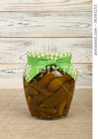 Jar of pickled small gherkin cucumbers on table Jar of pickled small gherkin cucumbers on table 36393253