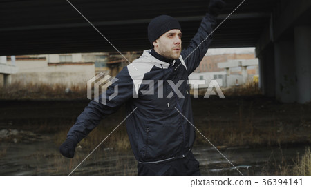 Attractive athlete man warming up before workout Attractive athlete man warming up before workout 36394141