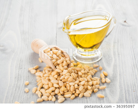 Pine nut oil and pine nuts on gray wooden Pine nut oil and pine nuts on gray wooden 36395097
