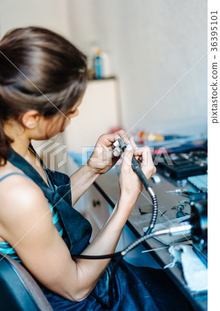 The girl is engaged in jewelry business The girl is engaged in jewelry business 36395101