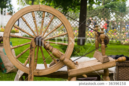 Old wooden worker spinning wheel 36396158