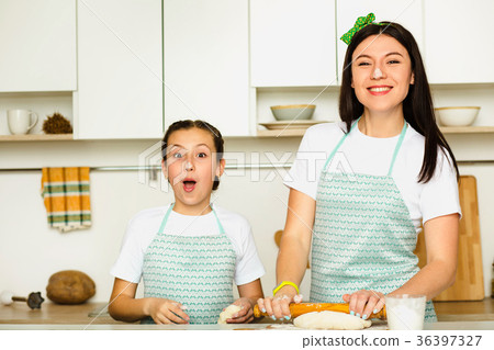 happy mother and daughter cooking dough happy mother and daughter cooking dough 36397327
