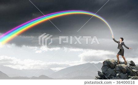 Woman catching rainbow Woman catching rainbow 36400018