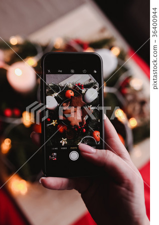 Woman's hand take a mobile photo of New Year's Woman's hand take a mobile photo of New Year's 36400944