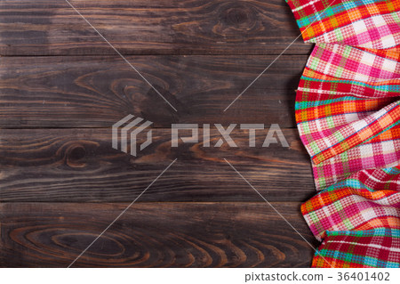 Red checkered tablecloth on a dark wooden table 36401402