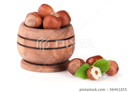 Hazelnuts with leaves in a wooden bowl isolated on 36401855