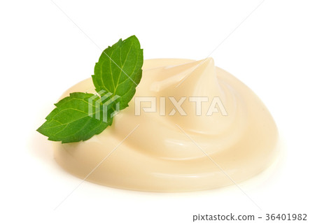 Mayonnaise swirl with a mint leaf isolated on a Mayonnaise swirl with a mint leaf isolated on a 36401982