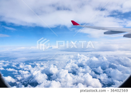 Clouds and sky as seen through window of an 36402569