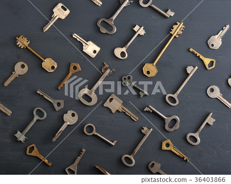 rusty old keys locks - on dark wooden background rusty old keys locks - on dark wooden background 36403866