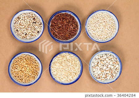 Variety of grain rice in cup on  brown paper 36404284