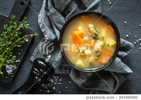 Fresh fish soup in bowl on dark background Fresh fish soup in bowl on dark background 36406000