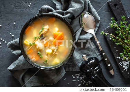 Fresh fish soup in bowl on dark background Fresh fish soup in bowl on dark background 36406001