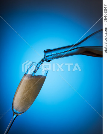 Pouring champagne from a bottle in a glass 36408847