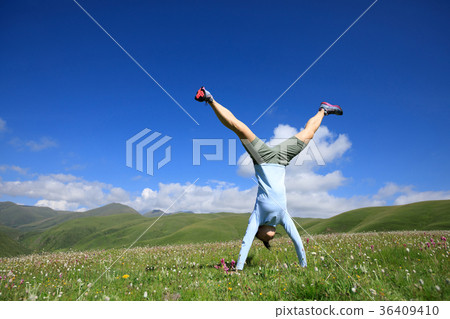 handstand woman have fun on mountain peak meadow handstand woman have fun on mountain peak meadow 36409410