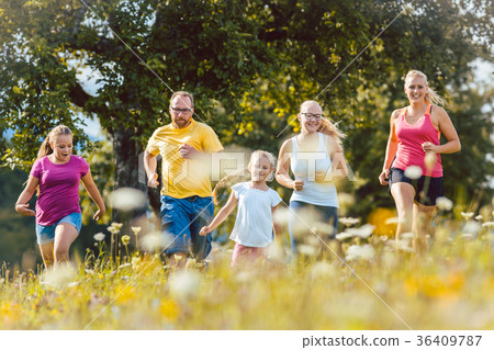 Family running on a meadow for sport Family running on a meadow for sport 36409787