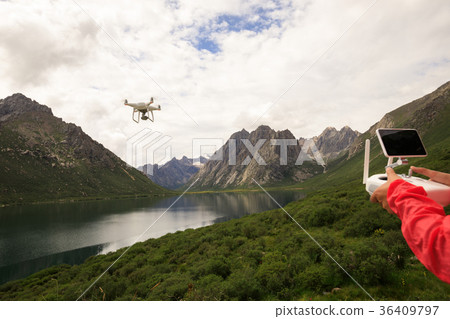 asian woman photographer flying drone outdoors 36409797