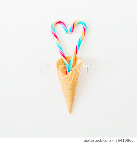 Bright candy cane and waffle cone on white Bright candy cane and waffle cone on white 36410863