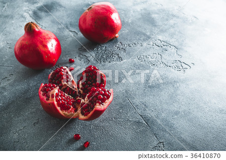 Red garnet fruit on dark table, winter fruit. Red garnet fruit on dark table, winter fruit. 36410870