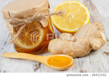 Fresh lemon, honey and ginger on wooden table Fresh lemon, honey and ginger on wooden table 36412542
