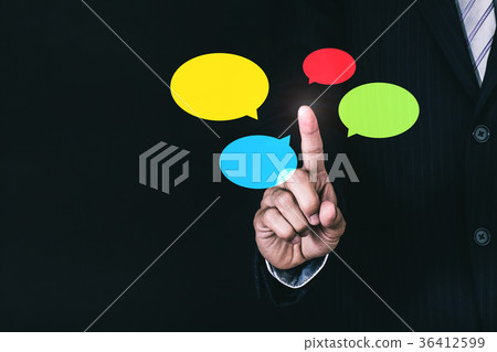 Businessman pointing at colorful speech bubble Businessman pointing at colorful speech bubble 36412599
