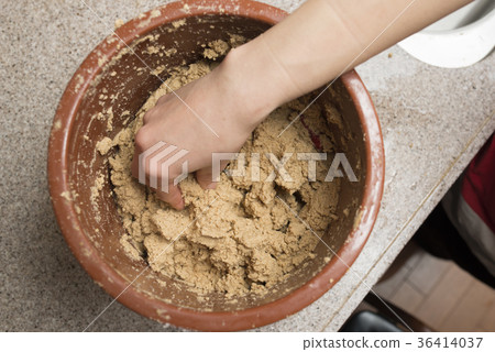 Female hand making braised pickle 36414037