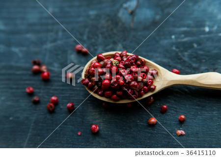 Pink peppercorn in wooden spoon studio shot Pink peppercorn in wooden spoon studio shot 36415110