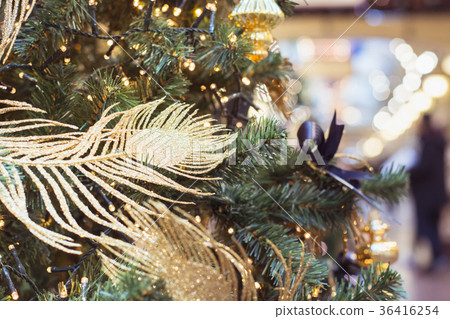 Christmas tree with golden decor and lights. 36416254