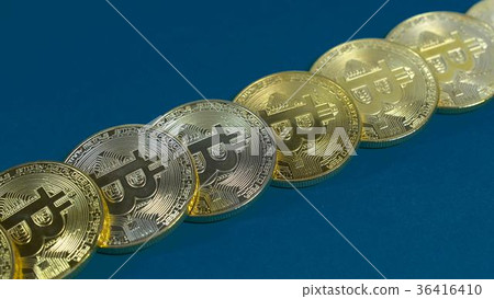 several coins of gold bitcoins on a dark 36416410