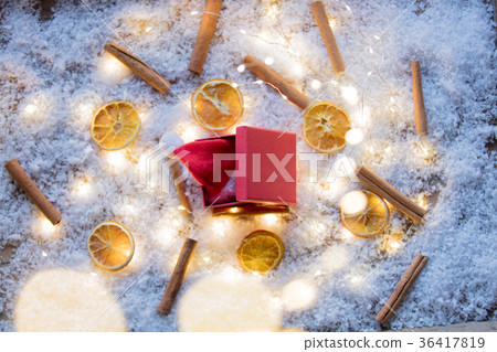 Gift box and lemons with connamon on snow background Gift box and lemons with connamon on snow background 36417819