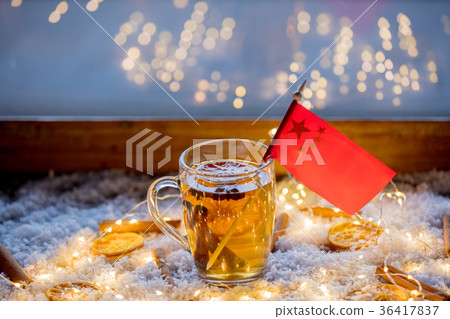 Cup of tea and flag of China on snow and fairy lights Cup of tea and flag of China on snow and fairy lights 36417837