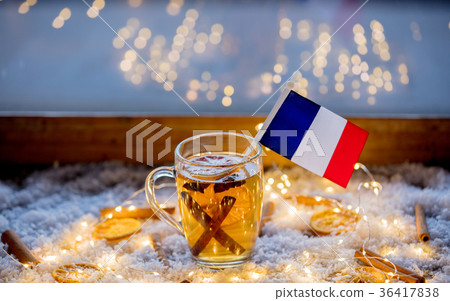 Cup of tea and flag of France on snow and fairy lights 36417838