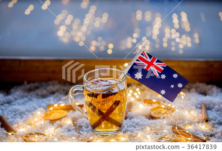 Cup of tea and flag of Australia on snow and fairy lights Cup of tea and flag of Australia on snow and fairy lights 36417839