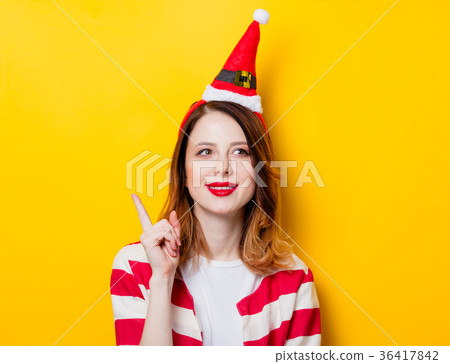 Portrait of young redhead woman in Santa Claus hat Portrait of young redhead woman in Santa Claus hat 36417842