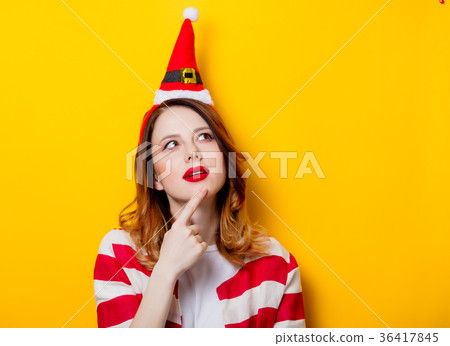 Portrait of young redhead woman in Santa Claus hat Portrait of young redhead woman in Santa Claus hat 36417845