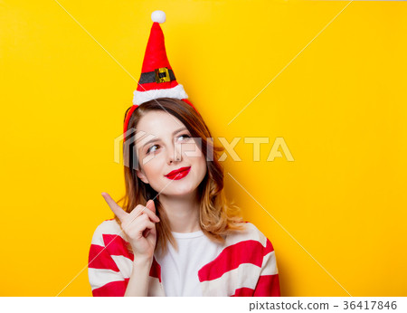 Portrait of young redhead woman in Santa Claus hat Portrait of young redhead woman in Santa Claus hat 36417846