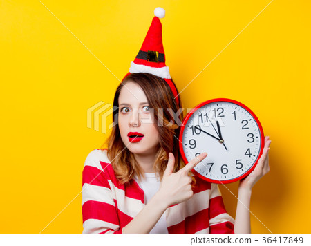 Woman in Santa Claus hat with clock Woman in Santa Claus hat with clock 36417849