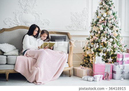 Two happy girls, mother and daughter siting on a Two happy girls, mother and daughter siting on a 36418915