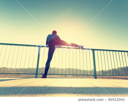 Morning runner in leggings makes body stretching Morning runner in leggings makes body stretching 36422041