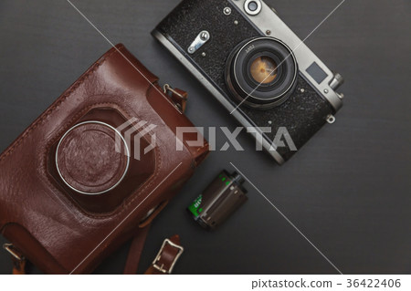 Old film camera and a roll of film Old film camera and a roll of film 36422406